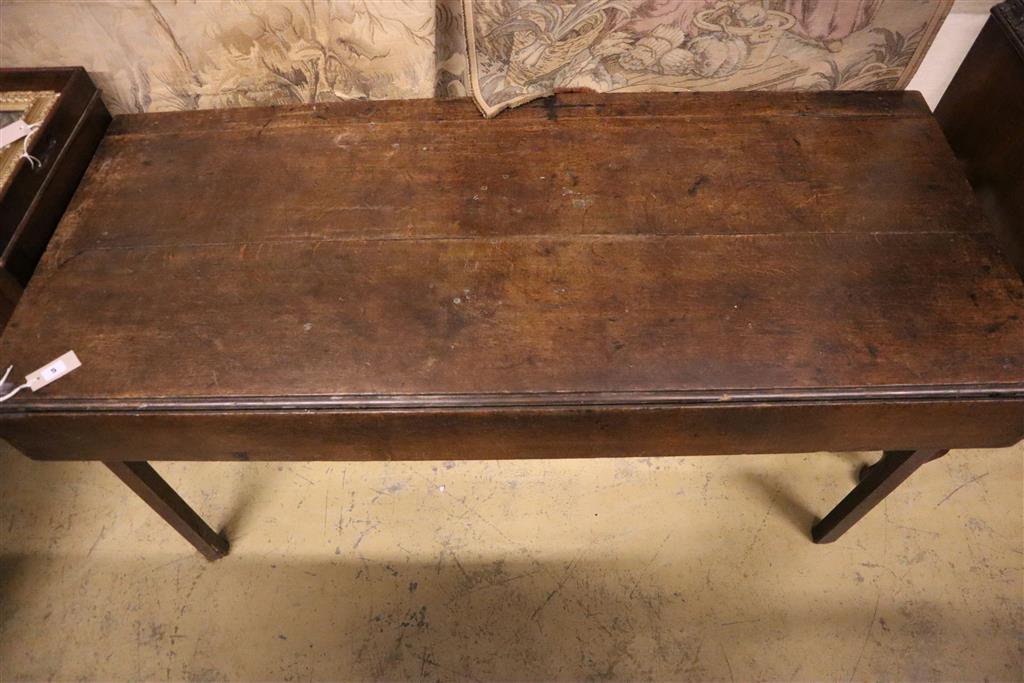 An 18th century provincial oak drop flap dining table, width 155cm, depth 66cm, height 71cm